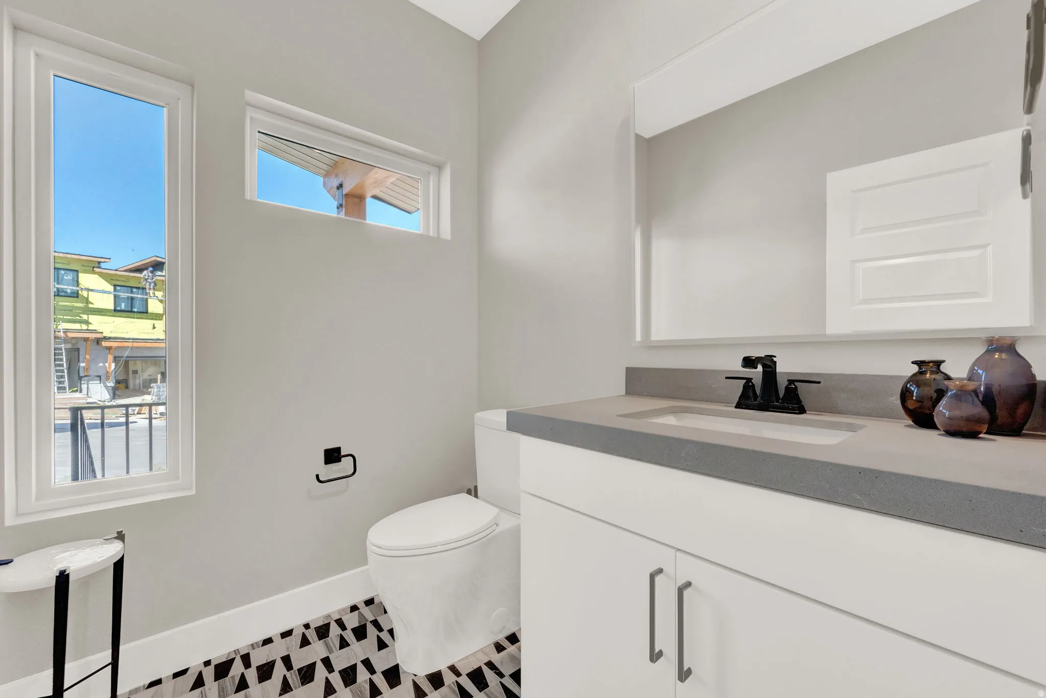 Half bathroom with toilet and vanity