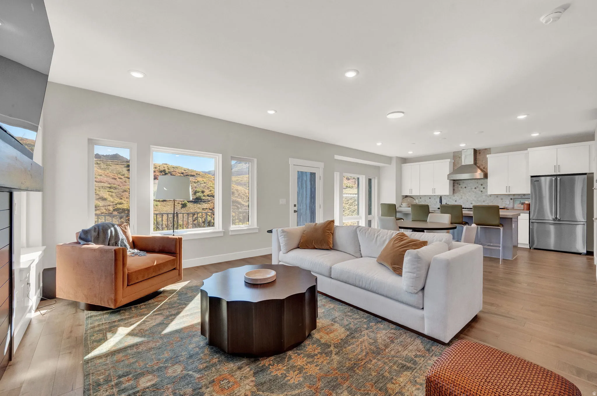 Living area with recessed lighting, light wood-style floors, healthy amount of natural light, and a fireplace