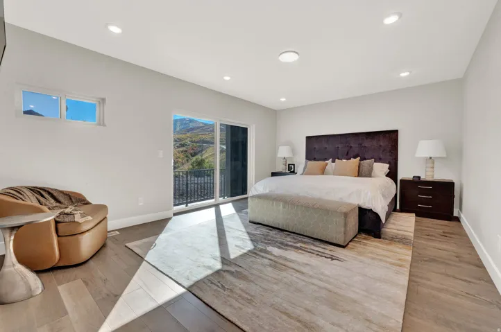 Bedroom featuring access to exterior, recessed lighting, and light wood-style floors