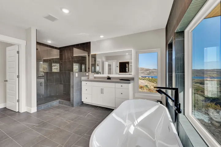 Full bathroom with a freestanding bath, vanity, a shower stall, and recessed lighting