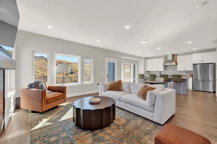 Living area with recessed lighting, light wood-style floors, healthy amount of natural light, and a fireplace