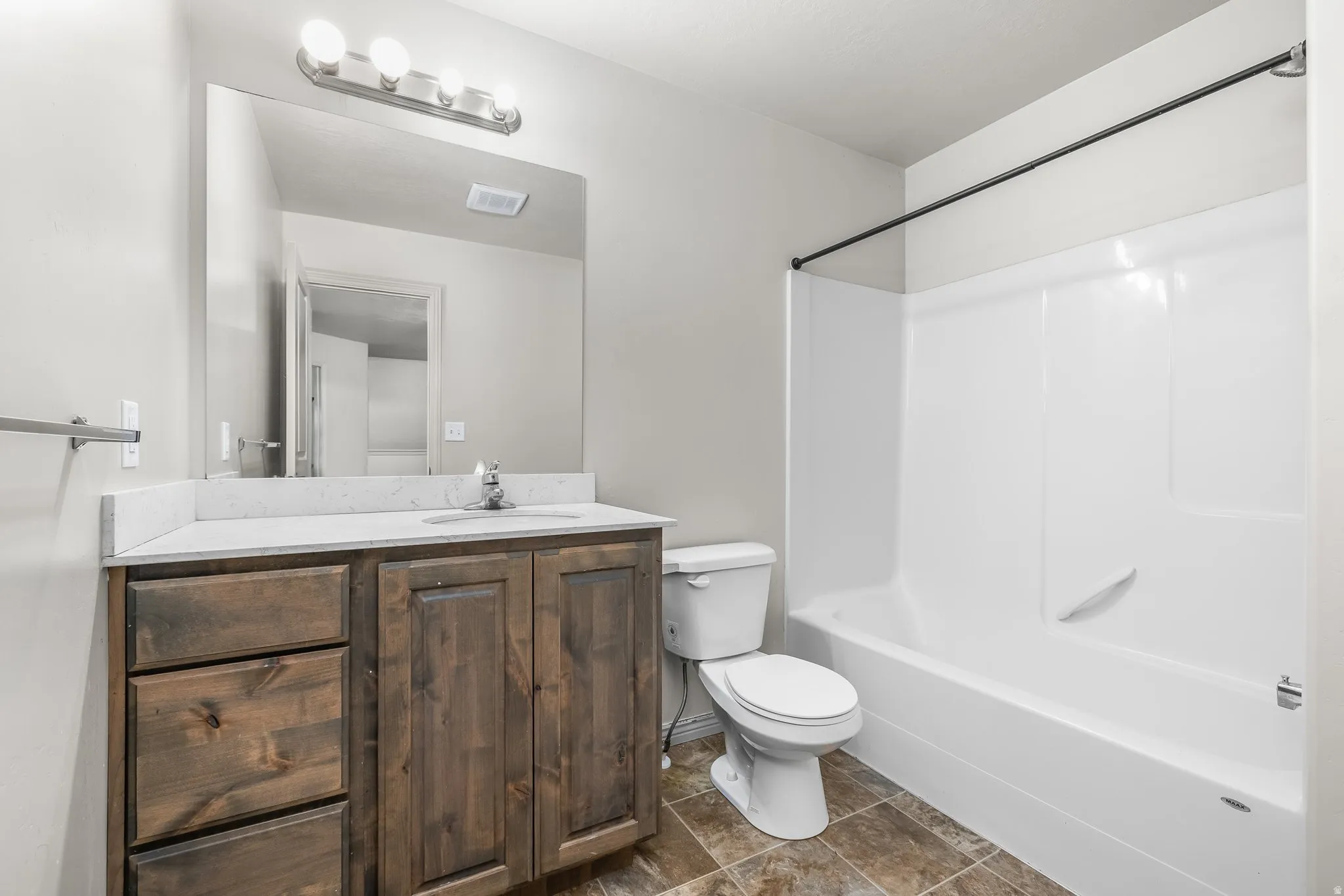 Bathroom with vanity and shower / tub combination
