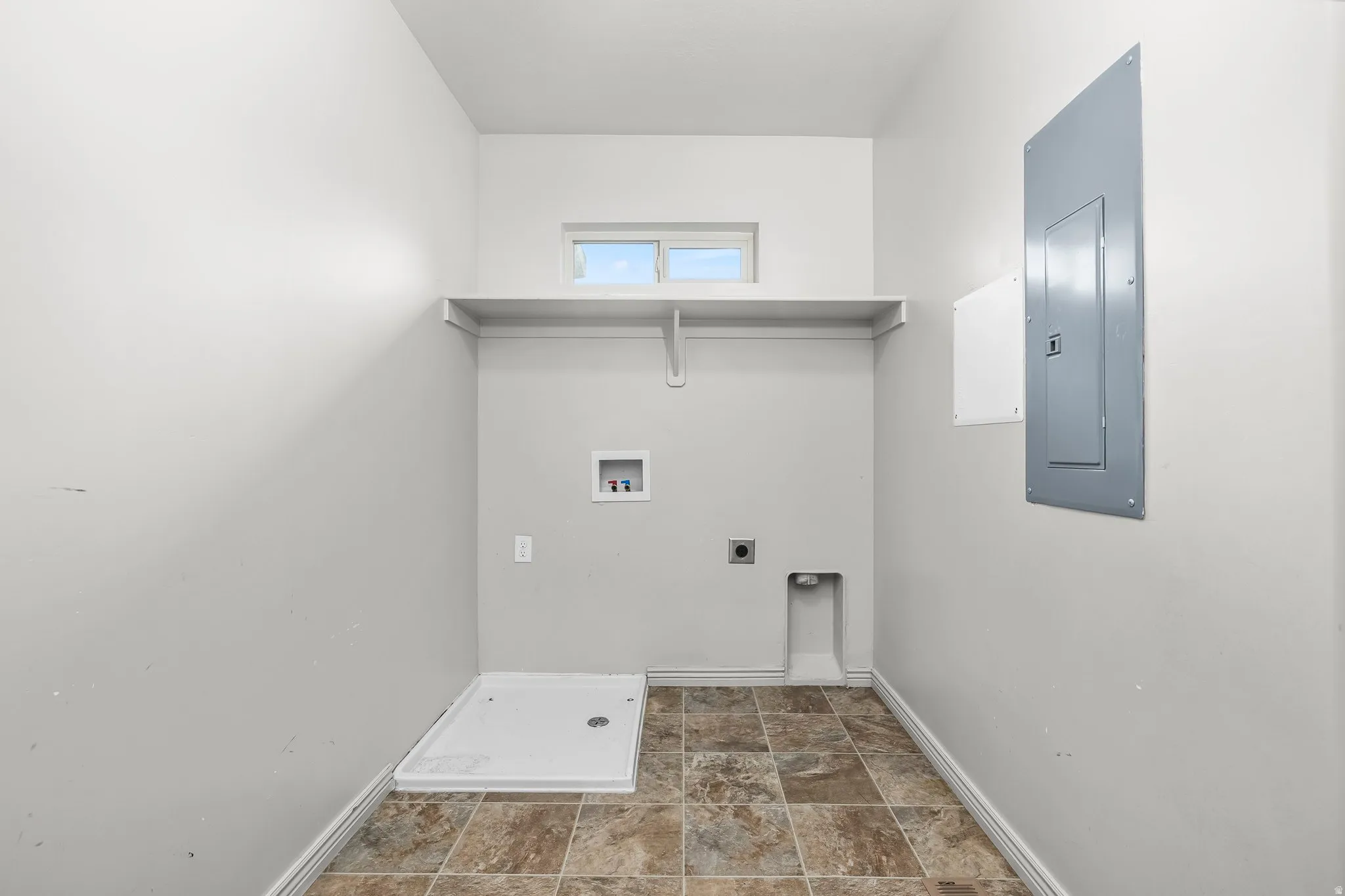 Washroom featuring electric panel, electric dryer hookup, and washer hookup