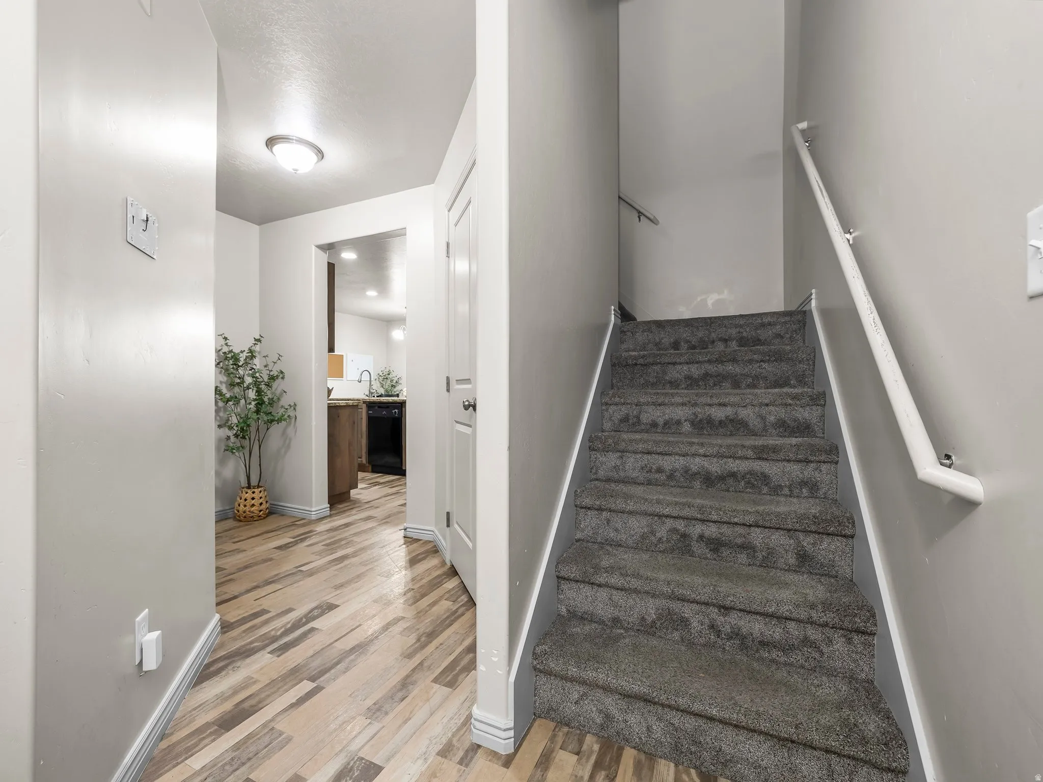 Stairway with baseboards and wood finished floors