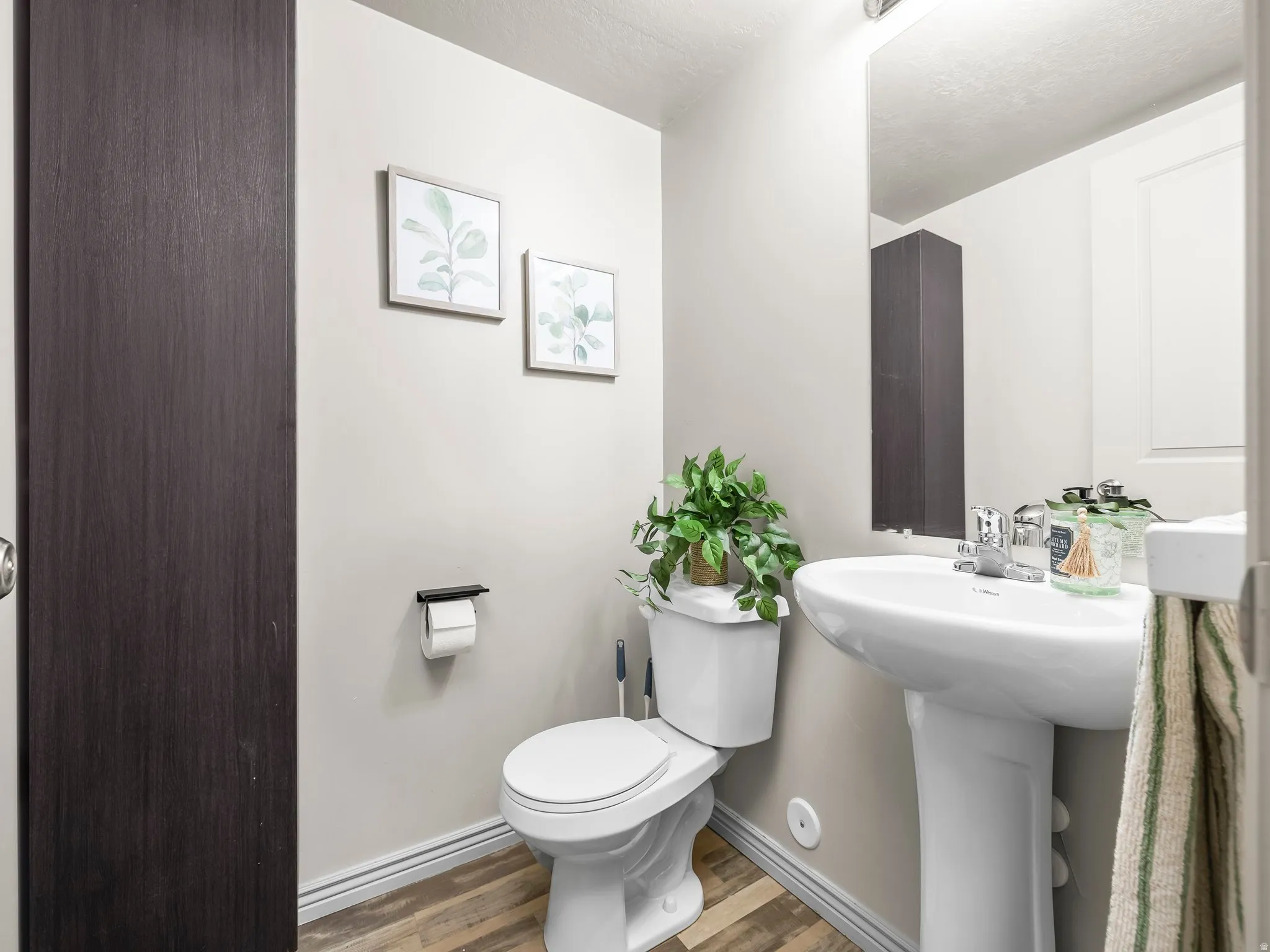 Bathroom with toilet and wood finished floors