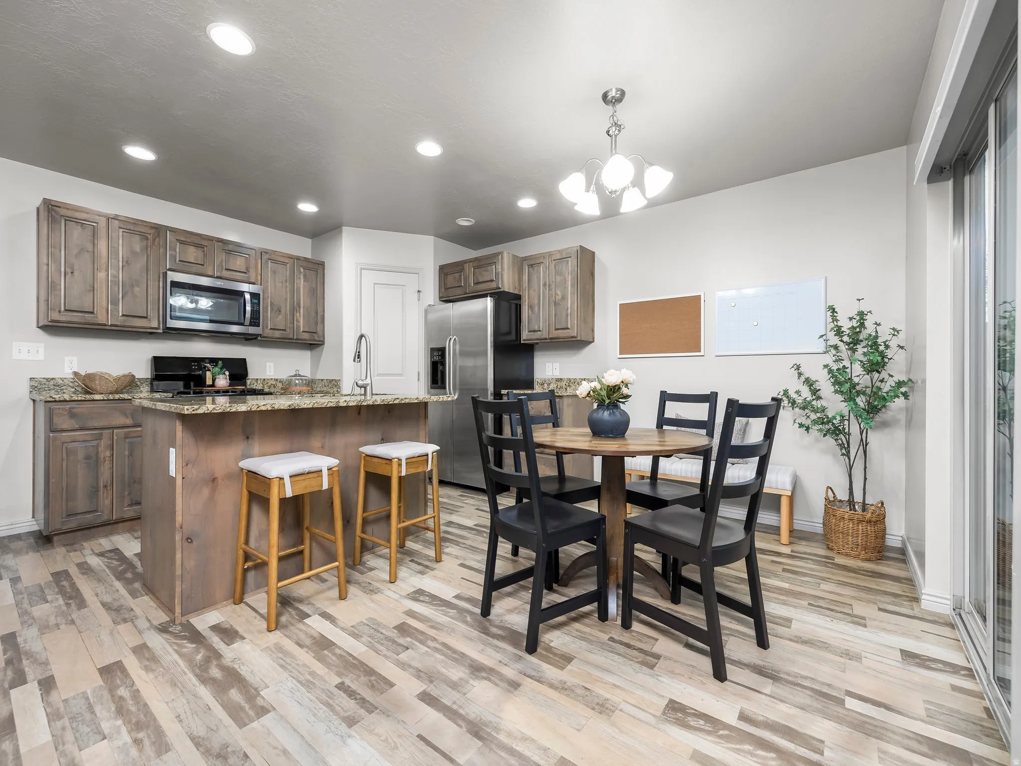 Dining room featuring a chandelier, light wood-style flooring, and recessed lighting