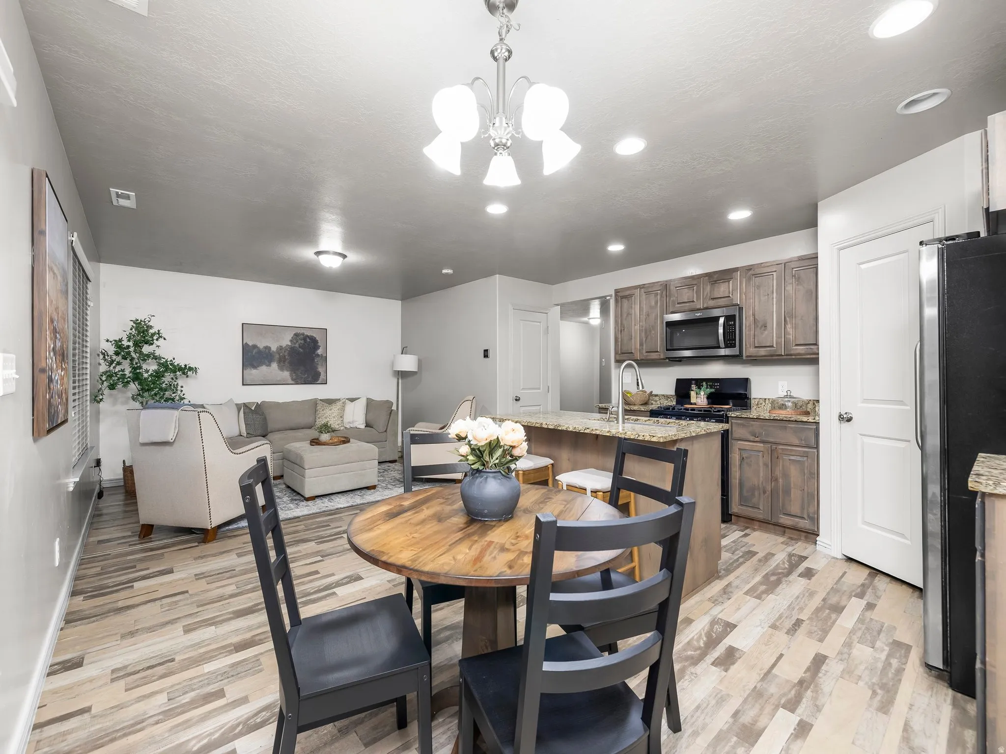 Dining room featuring a chandelier, light wood-style flooring, and recessed lighting
