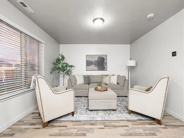 Living area featuring light wood-style floors and baseboards