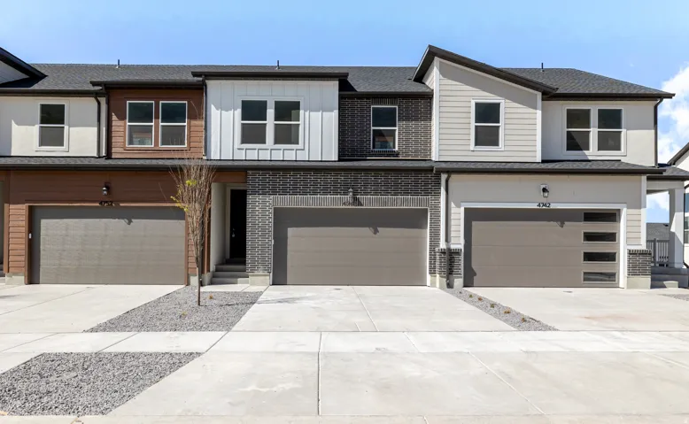 View of front of property featuring concrete driveway, a garage, and board and batten siding