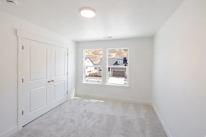 Unfurnished bedroom with carpet floors, a closet, and a textured ceiling