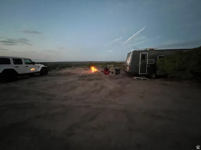 View of parking / parking lot with an outdoor fire pit