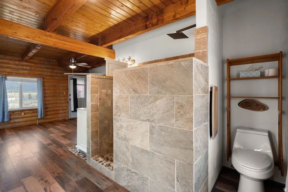 Full bathroom featuring walk in shower, dark wood-style floors, a wood ceiling with exposed beams, and ceiling fan