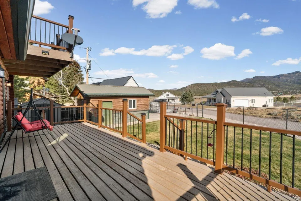 Deck featuring an outbuilding, a fenced backyard, and a residential view