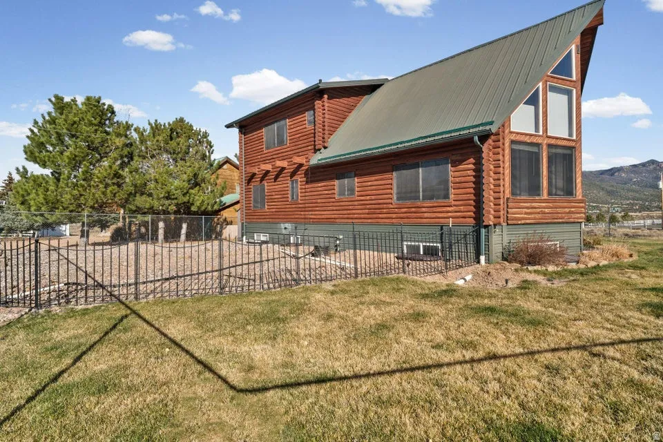 View of home's exterior featuring a metal roof and log exterior
