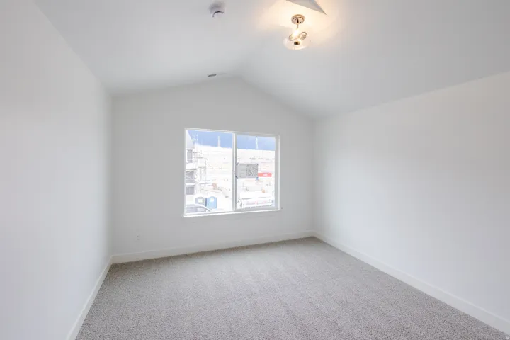Unfurnished room with light carpet and baseboards