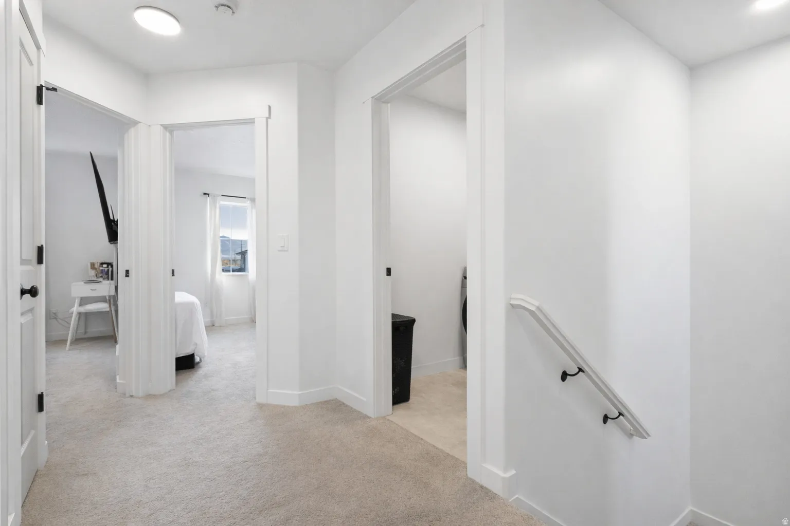 Corridor featuring an upstairs landing, light carpet, and recessed lighting