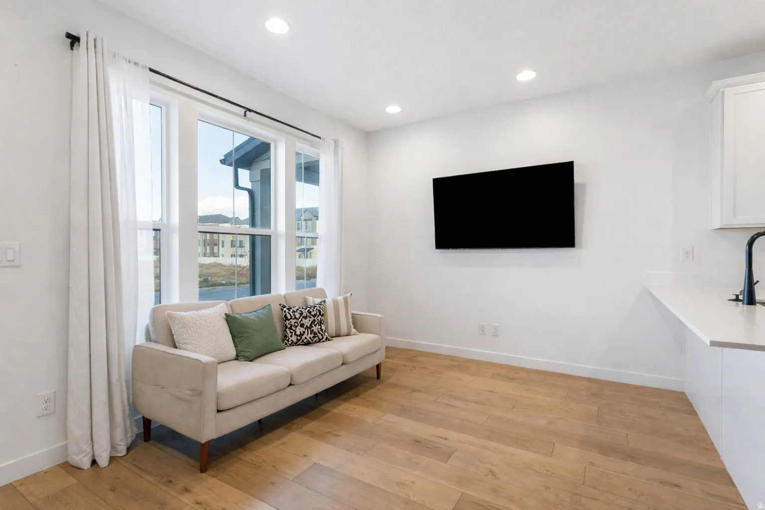 Living room featuring light wood-type flooring and recessed lighting