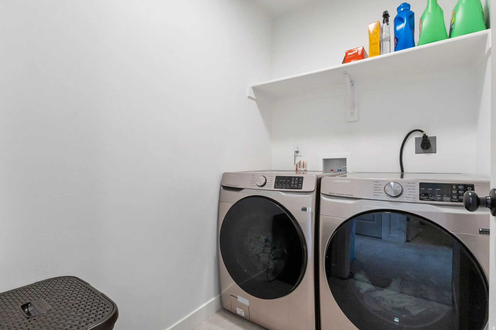 Laundry area featuring baseboards and separate washer and dryer