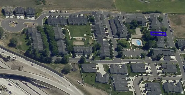 Aerial view of property's location with nearby suburban area