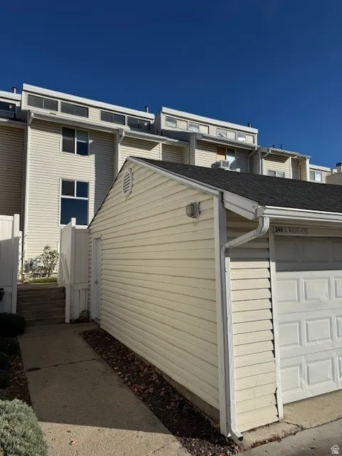 View of side of property with a garage