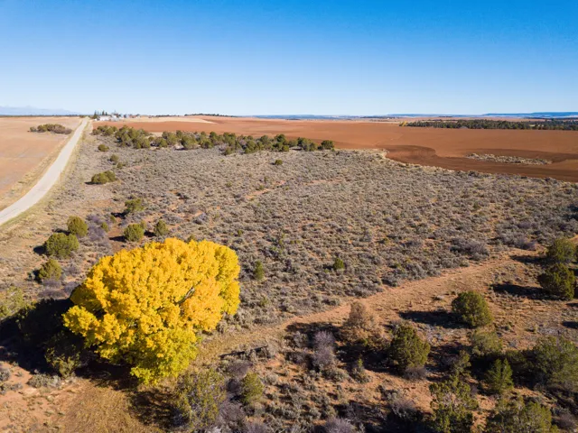 Aerial view of property and surrounding area featuring rural landscape and a desert landscape