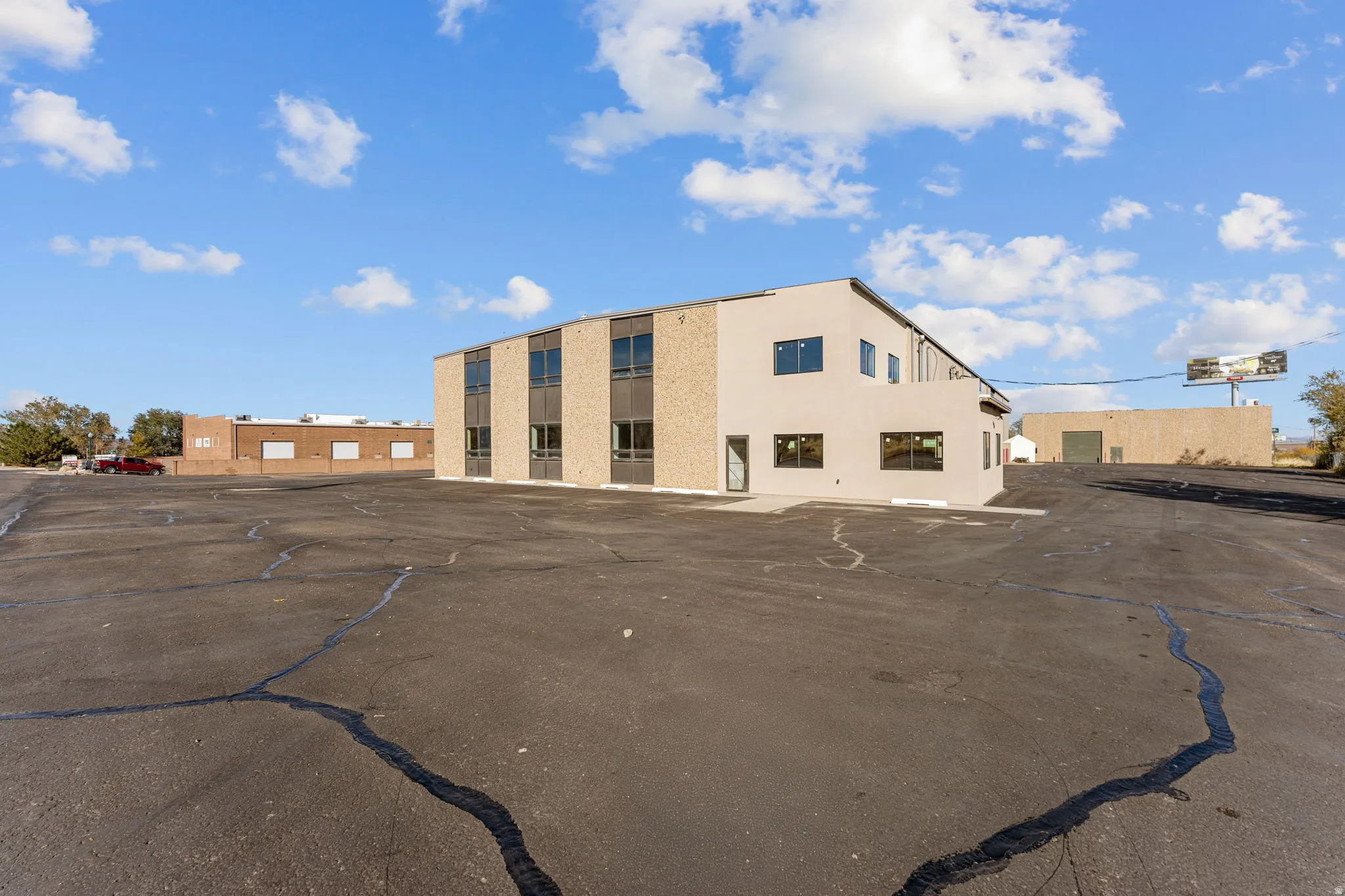 View of building exterior featuring uncovered parking