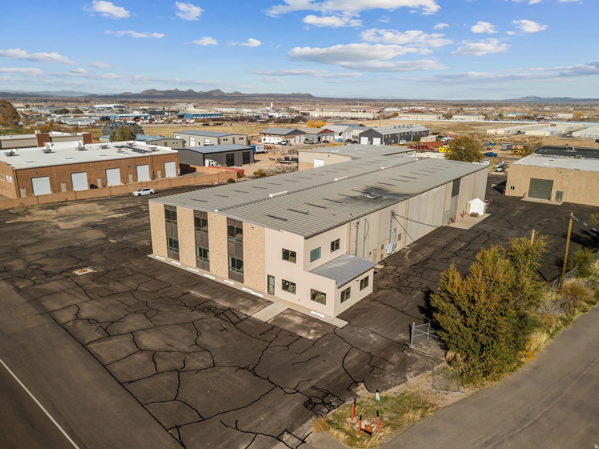 Aerial view of industrial structures and a mountain backdrop