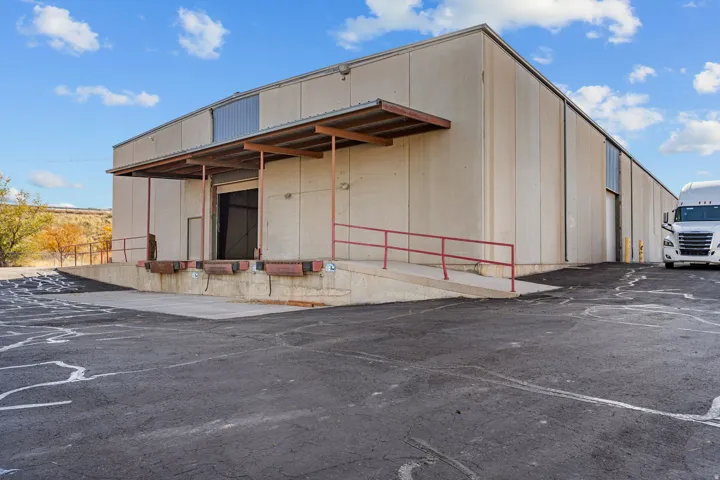View of property featuring uncovered parking
