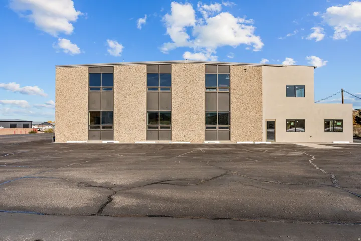 View of property featuring uncovered parking