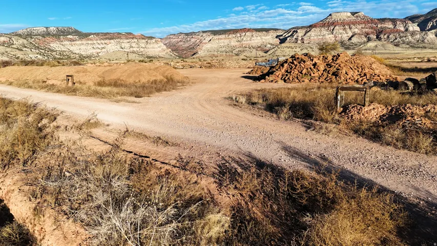 Expansive land parcel with natural terrain and distant mountainous backdrop