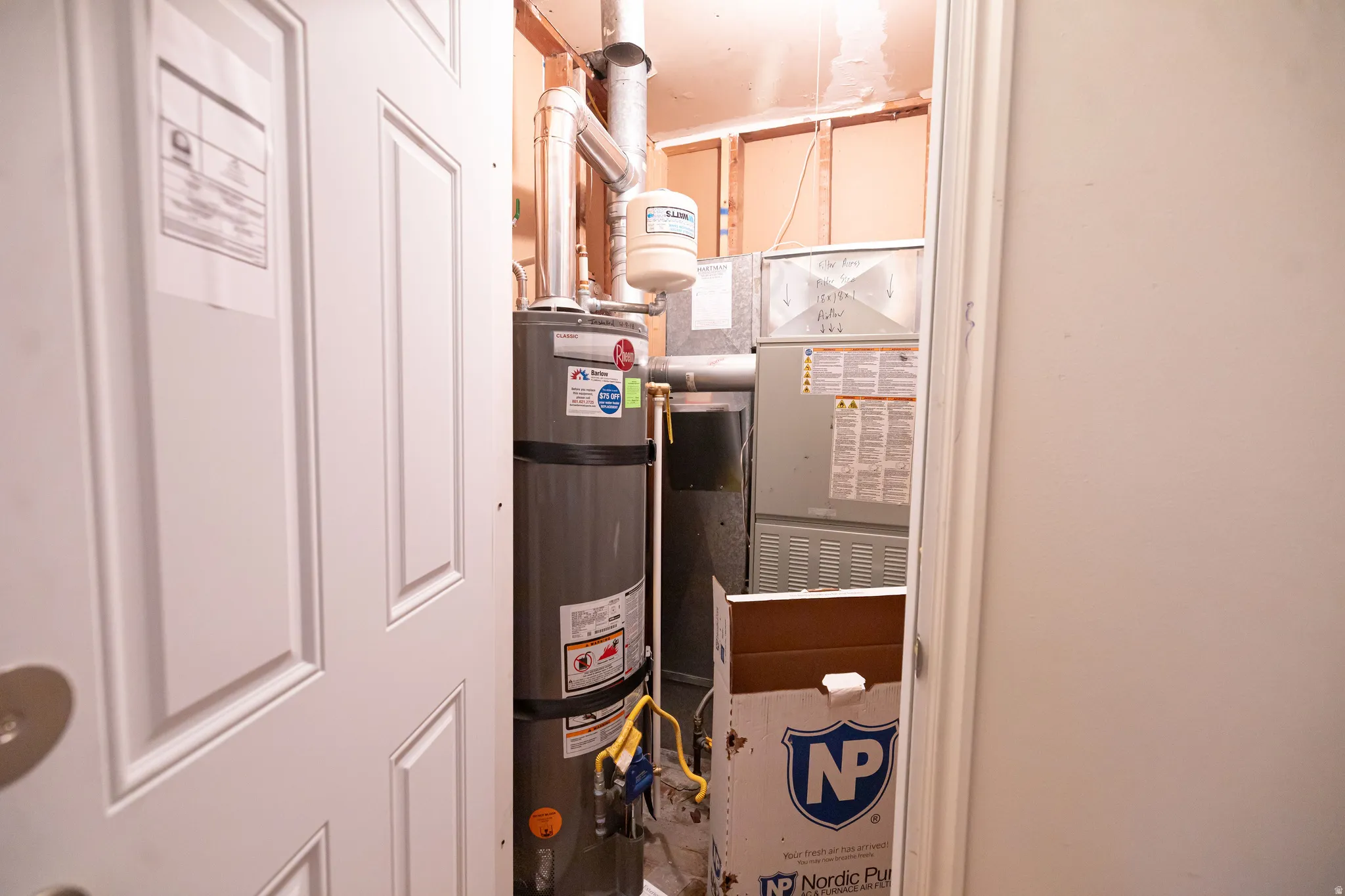 Utility room featuring water heater