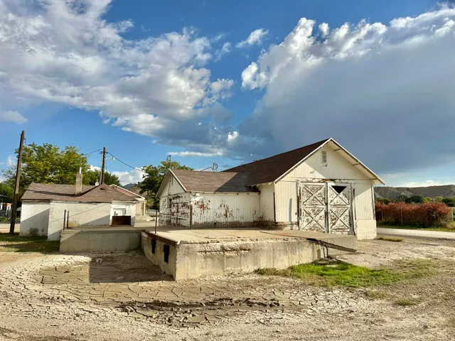 Rear view of property featuring an outbuilding and a barn