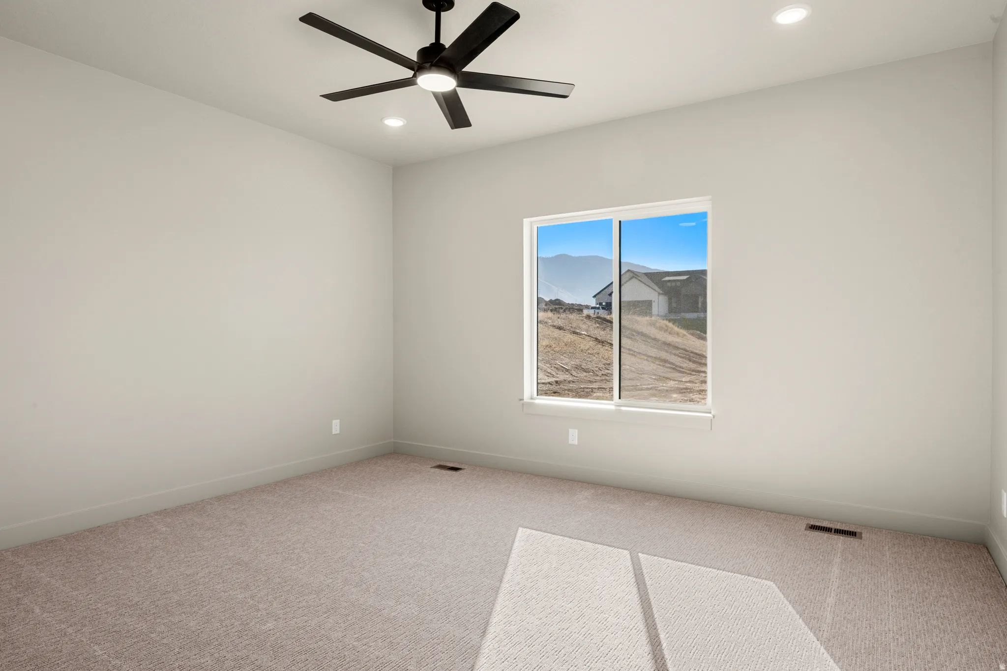 Carpeted spare room with recessed lighting and a ceiling fan