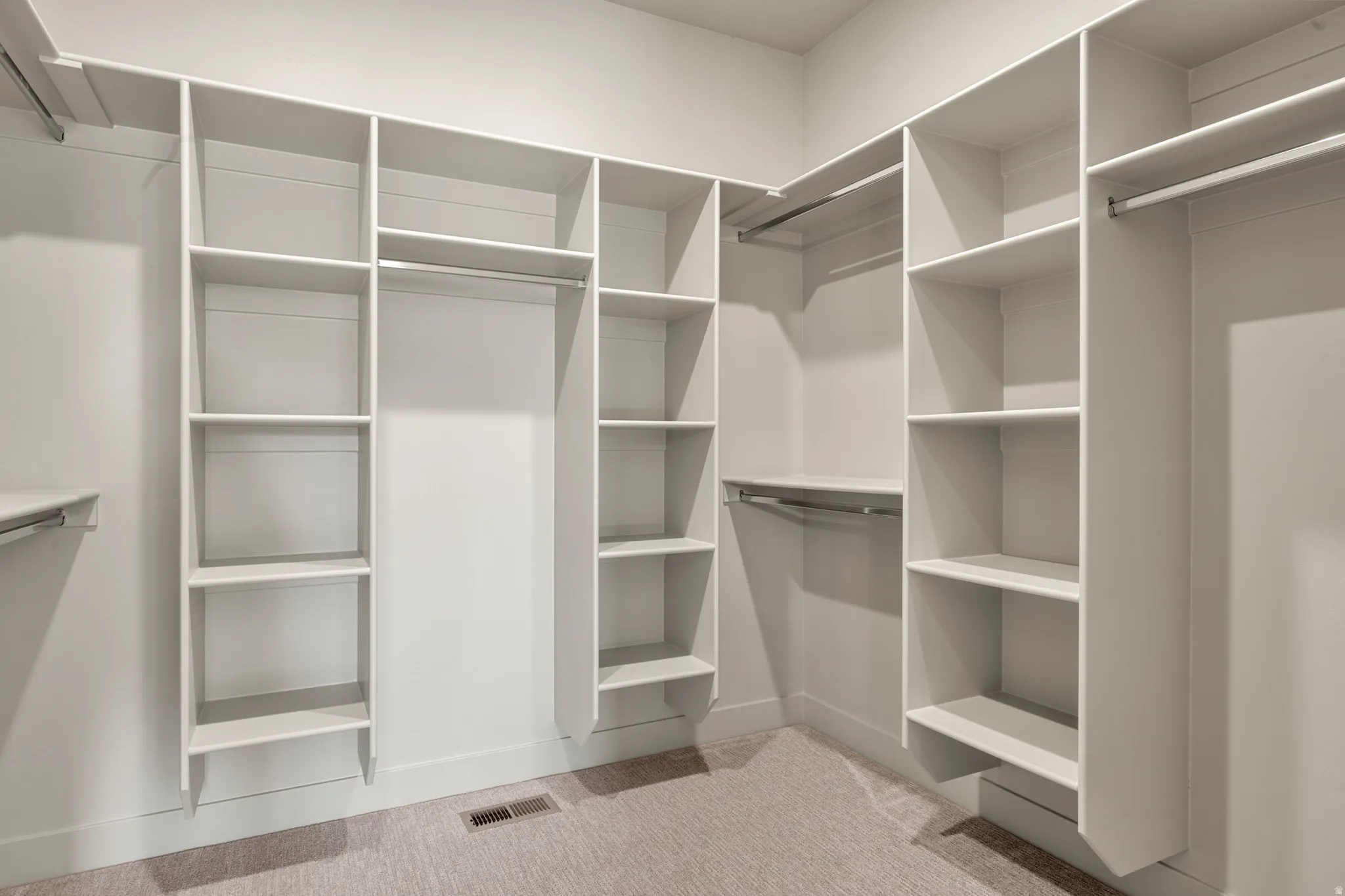 Walk in closet with light carpet