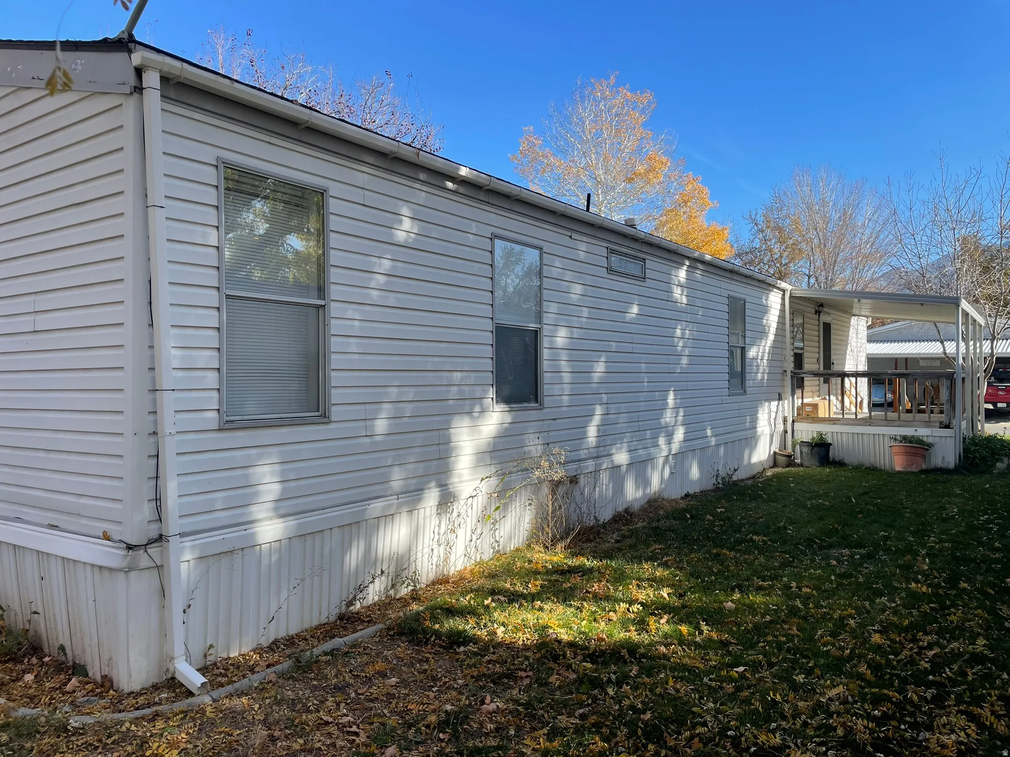 View of side of property featuring a yard and a deck