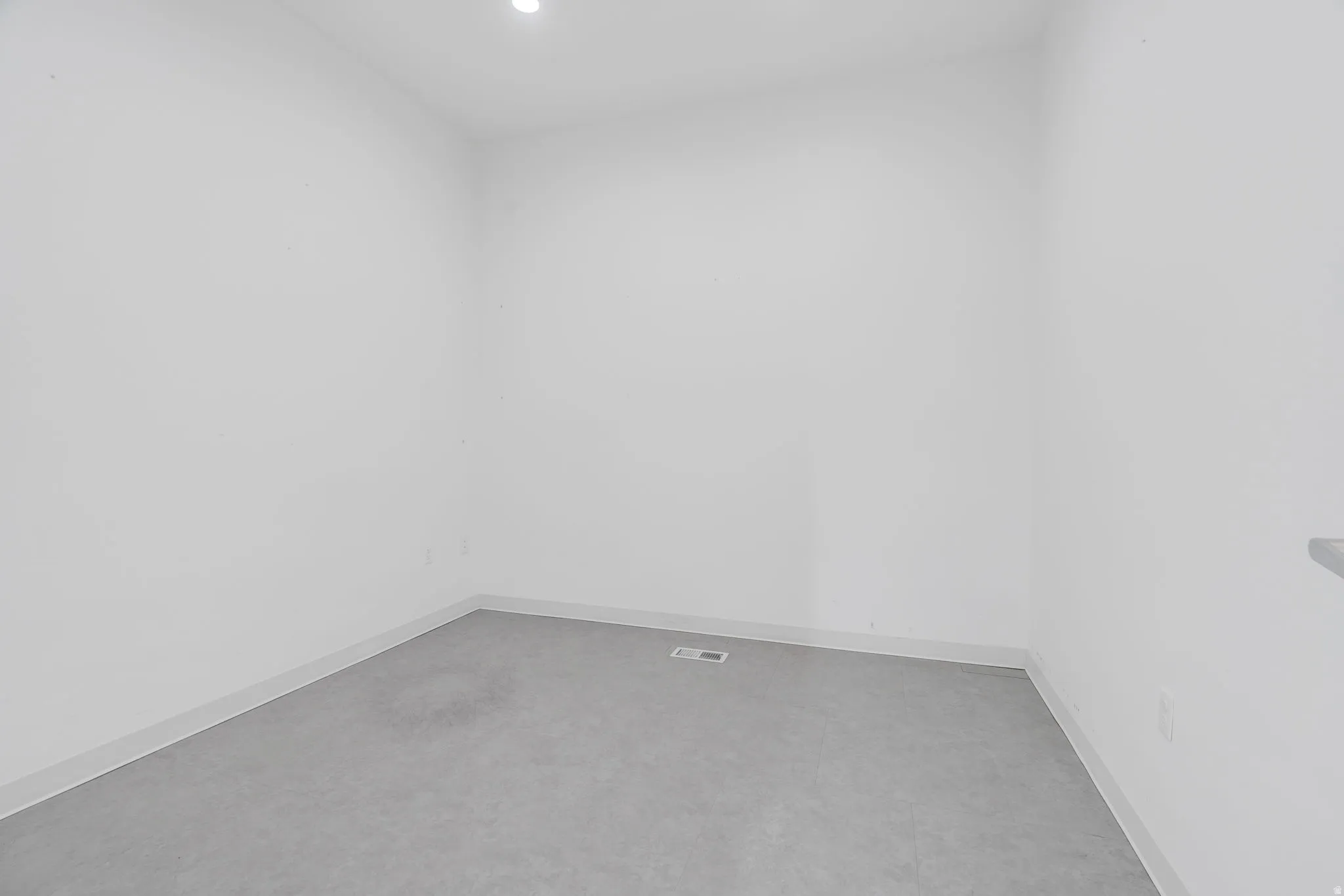 Empty room with baseboards and recessed lighting