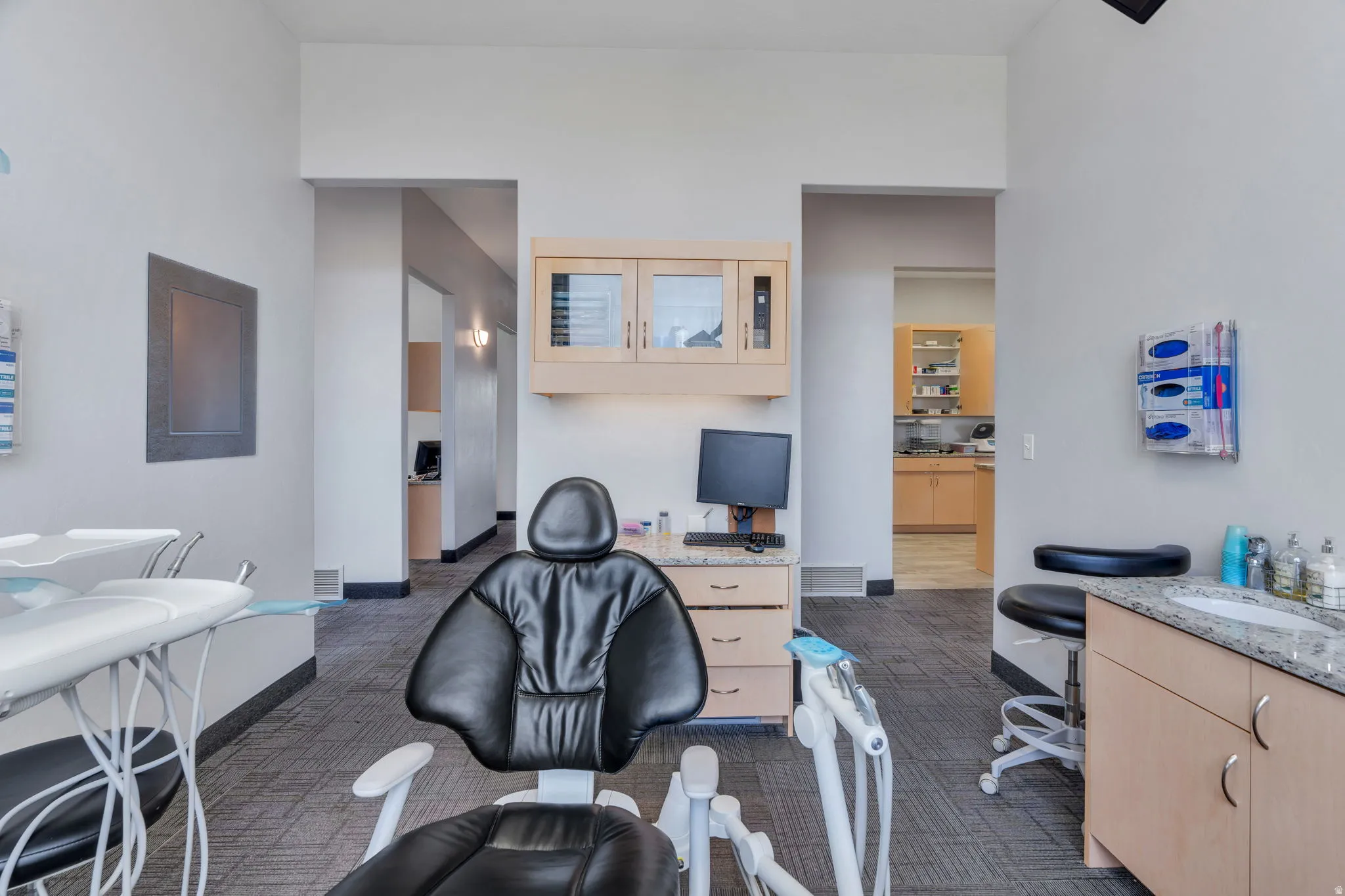 Home office featuring dark carpet and baseboards