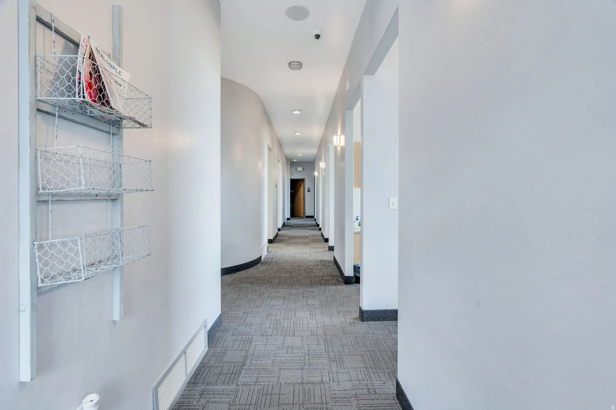 Corridor featuring light carpet and recessed lighting