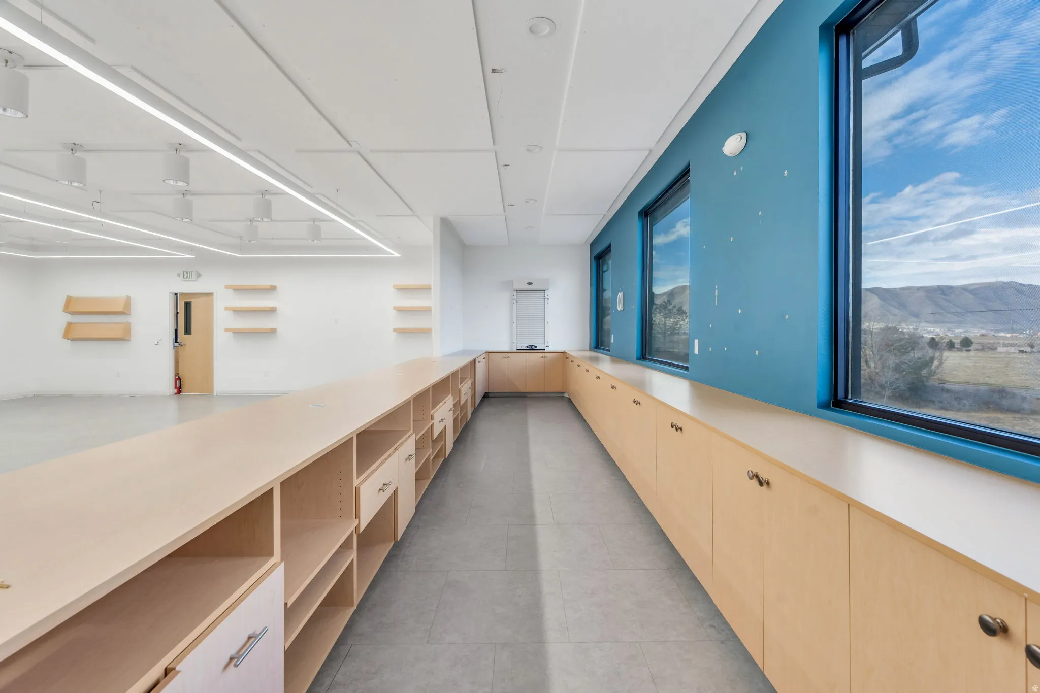Corridor featuring a mountain view and light tile patterned floors