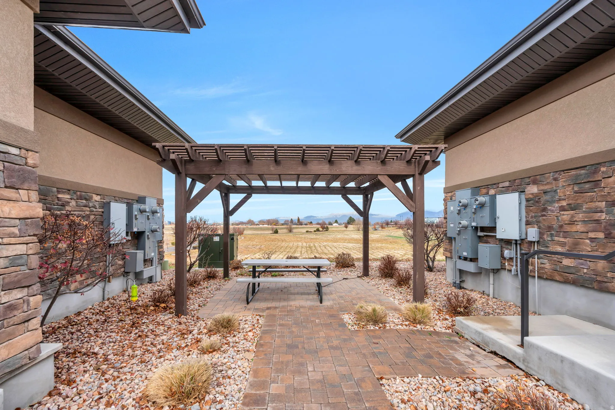 View of patio / terrace featuring a pergola, a rural view, and mail area