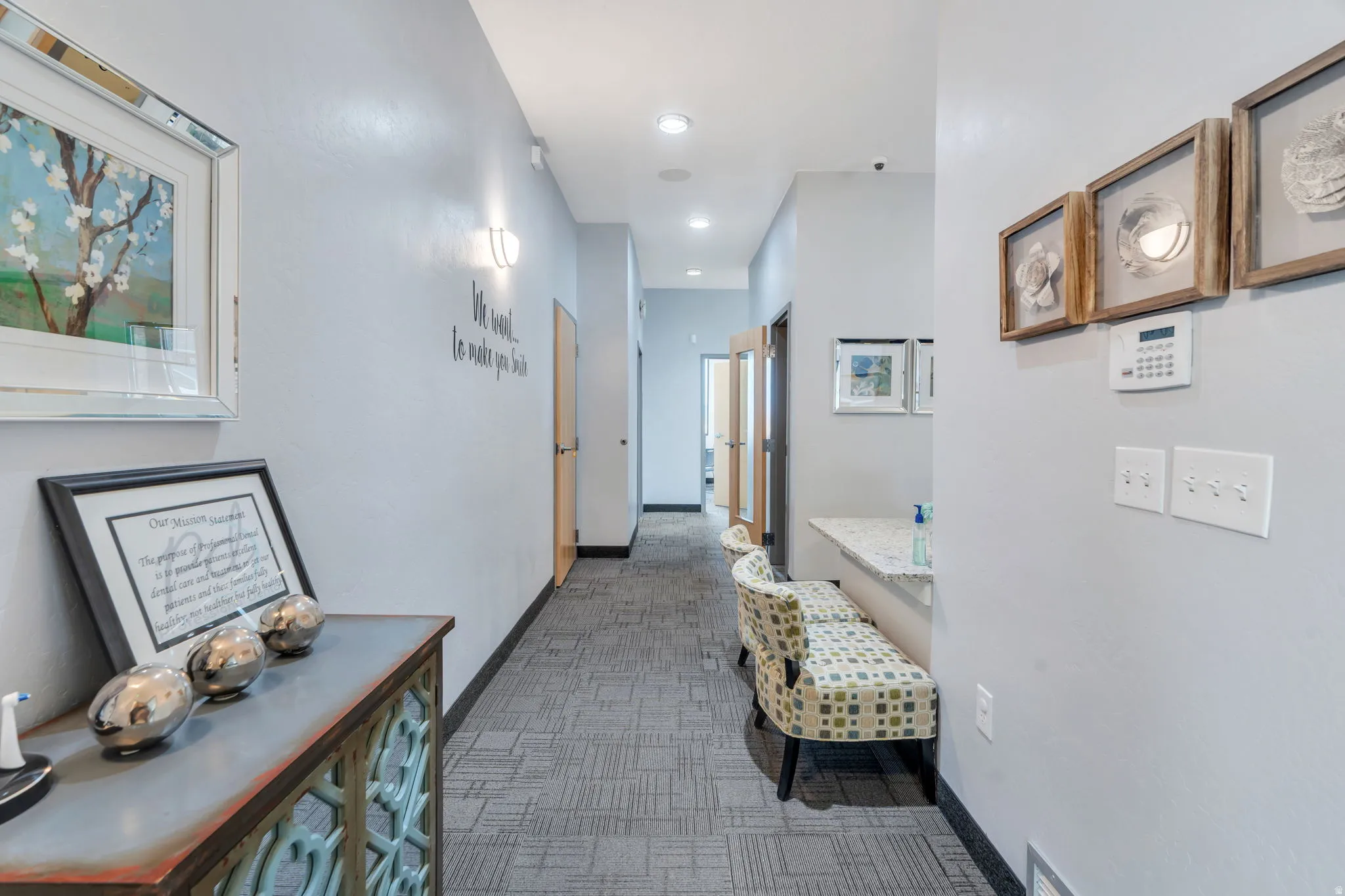 Corridor with dark carpet and recessed lighting