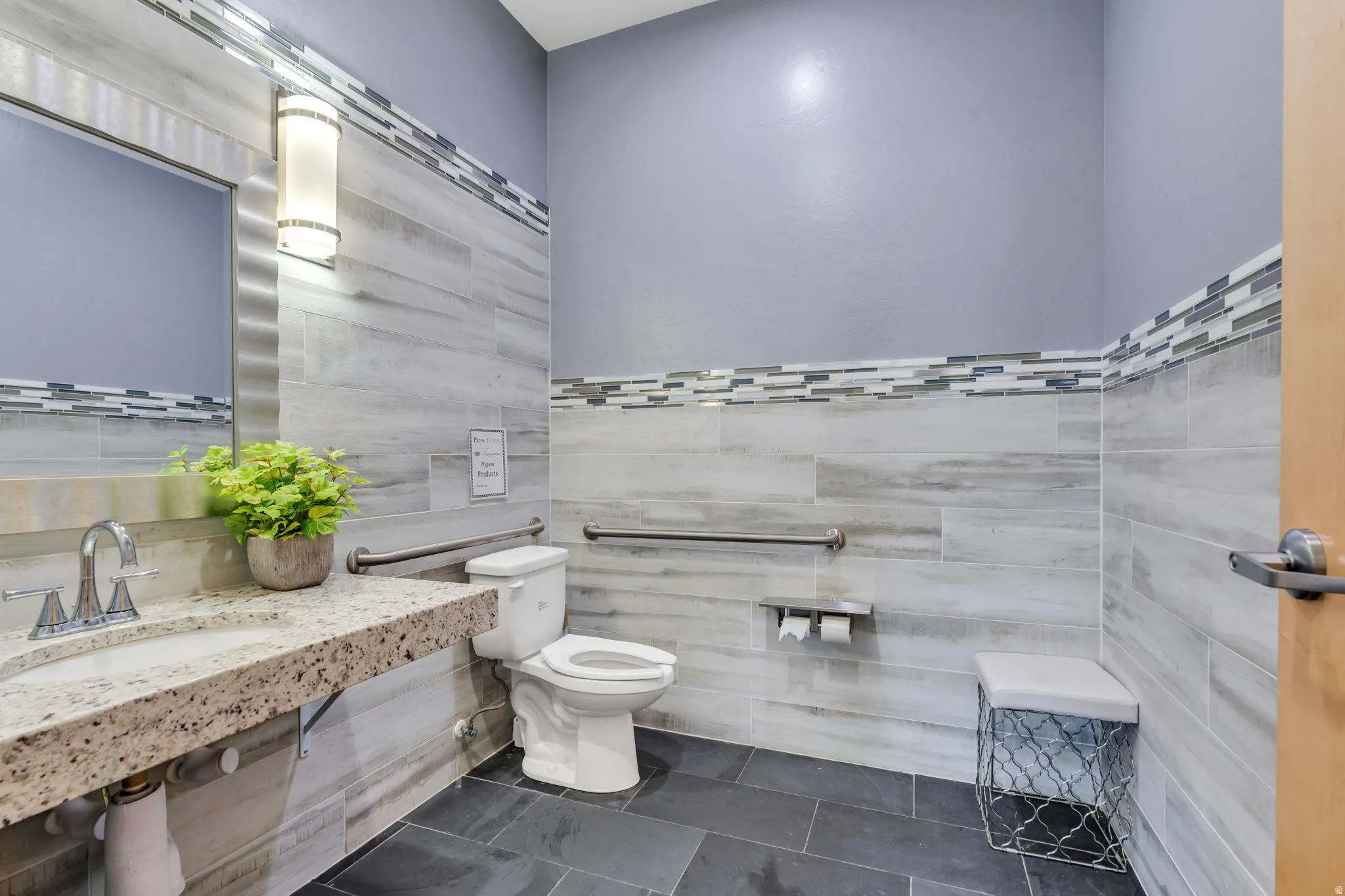 Bathroom with vanity, tile walls, and dark tile patterned floors