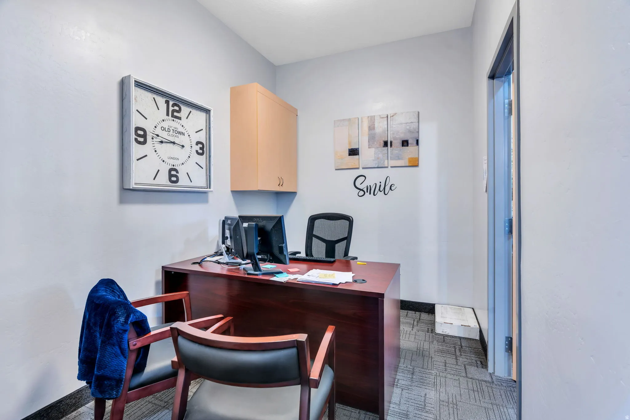 Home office featuring dark floors and baseboards