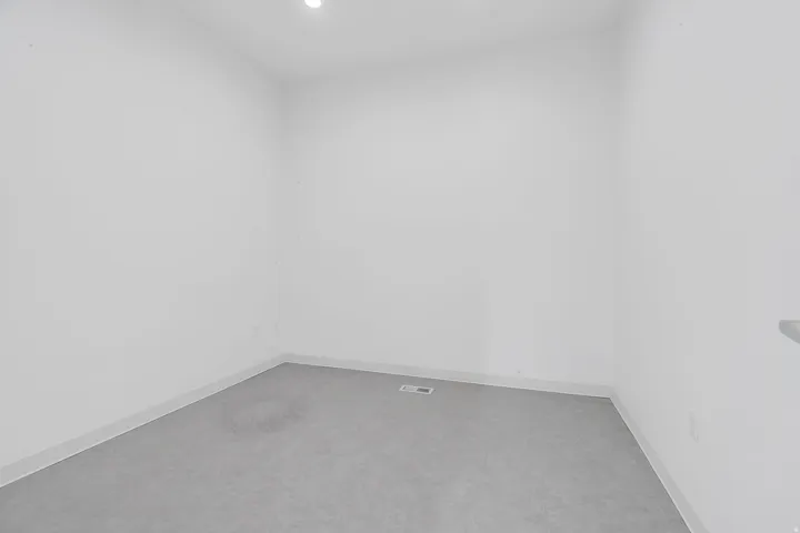 Empty room with baseboards and recessed lighting