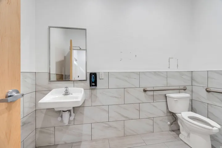 Bathroom featuring tile walls, a wainscoted wall, and tile patterned flooring