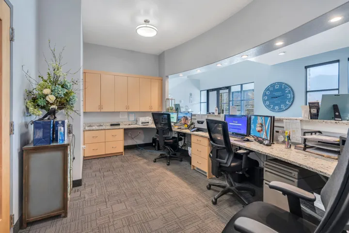 Office with built in study area, dark carpet, and recessed lighting
