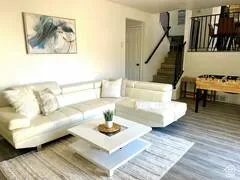 Living room featuring wood finished floors and stairway