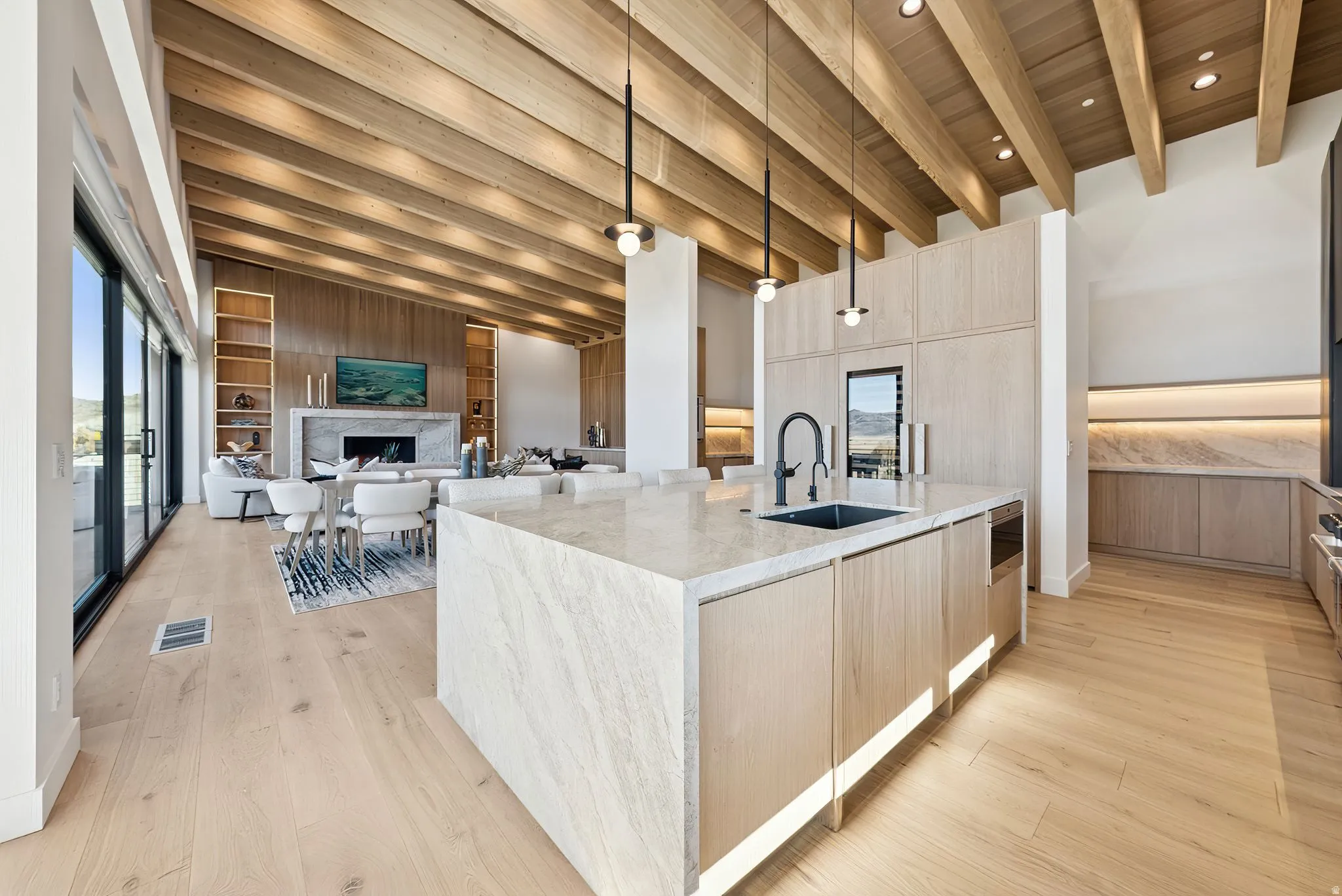 Kitchen with light brown cabinetry, modern cabinets, light stone countertops, a wooden ceiling with exposed beams, and recessed lighting