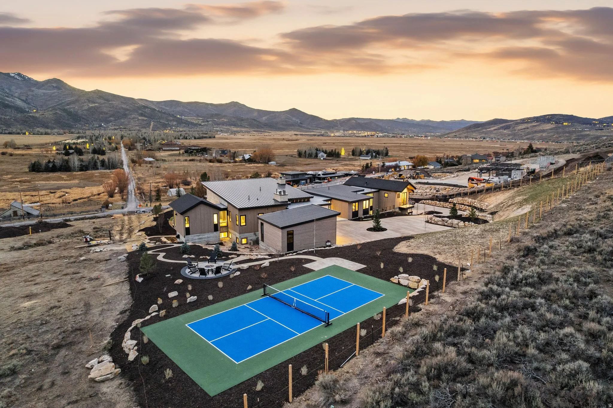 Aerial view of property and surrounding area featuring a mountainous background
