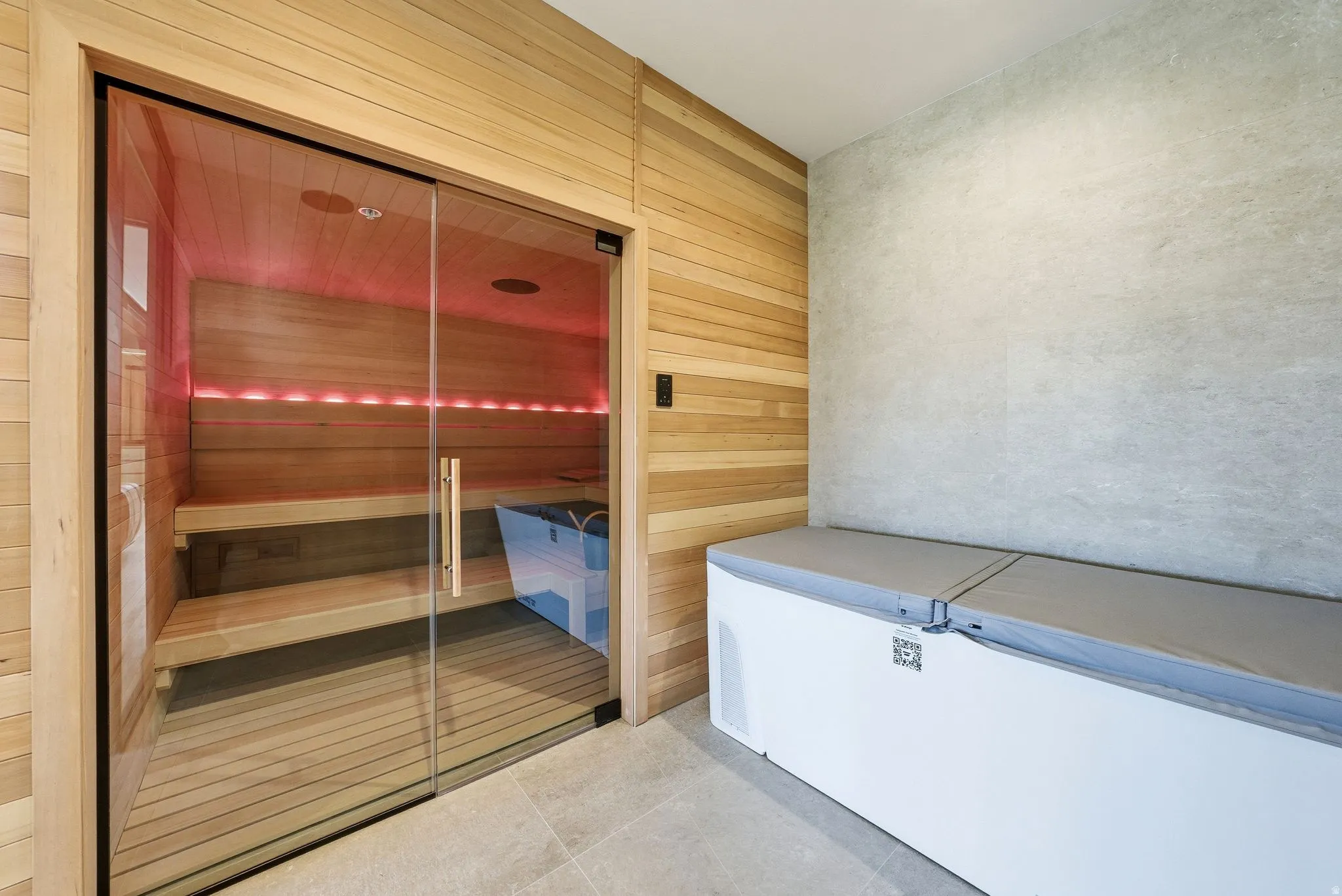 Relaxing sauna with tile patterned floors and wood walls